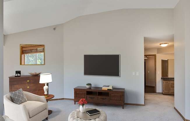 a living room with a couch and a tv on the wall