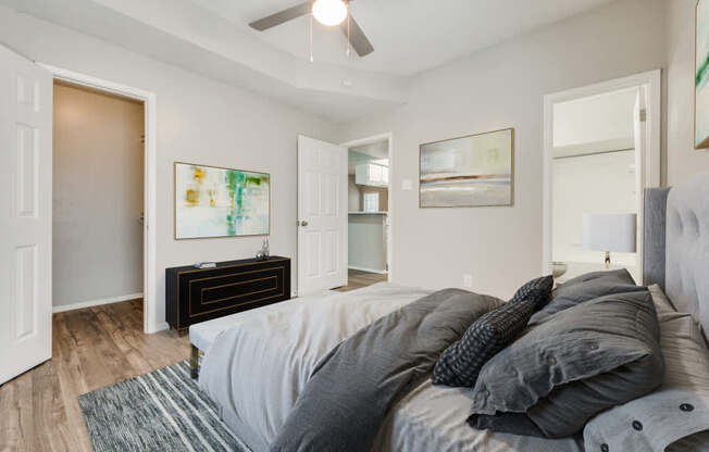 a bedroom with a large bed and a ceiling fan at Foxborough Apartments, Irving, TX, Texas, 75061