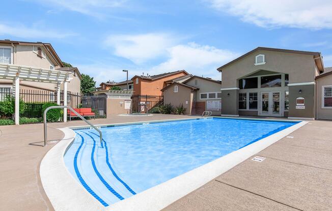 a house with a pool in front of a building