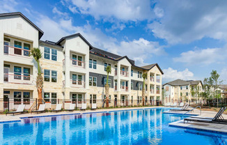 a large swimming pool in front of an apartment building at Legacy at Cibolo, Boerne, TX