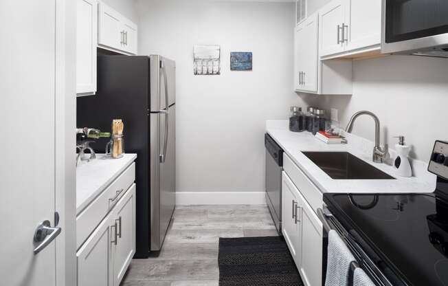 Fully Equipped Kitchen Includes Frost-Free Refrigerator, Electric Range, & Dishwasher at The Luckman, Ohio, 44114