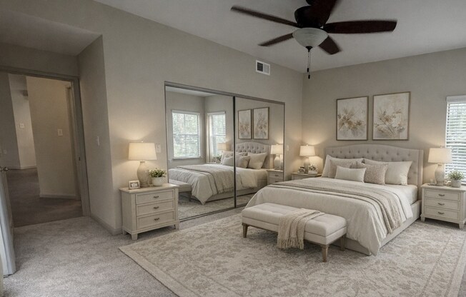 A bedroom with two beds, a dresser, and a ceiling fan.