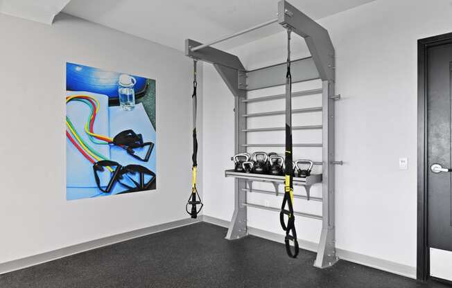 a room with a ladder and equipment in it and a painting on the wall