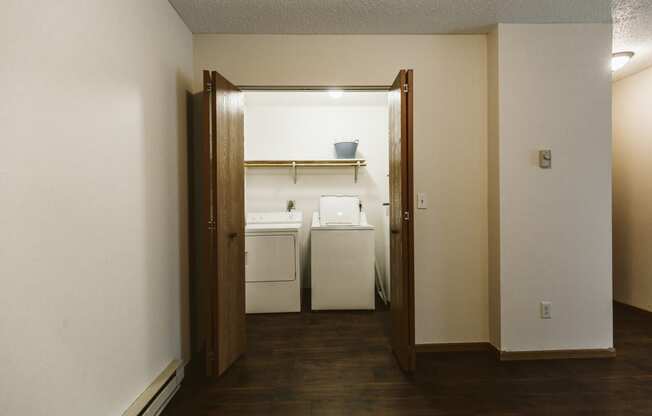 Grand Forks Harrison Apartments. A dining room with a door open to a kitchen and laundry room