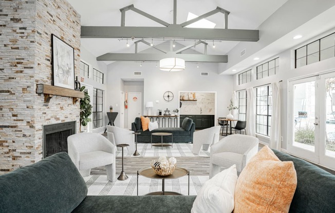a living room with couches and chairs and a fireplace
