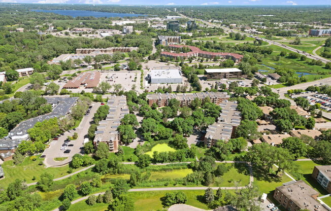 A bird's eye view of a campus with a large building in the center.