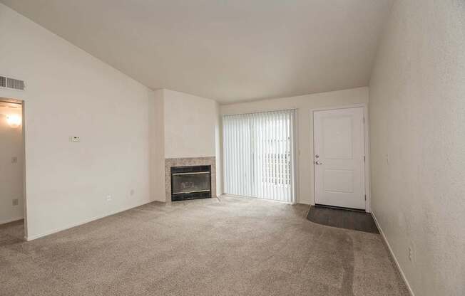 A room with a fireplace and a door at Pepperwood Apartments, California, 95661