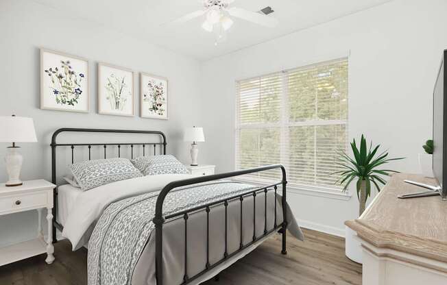 A bedroom with a bed, nightstand, and a television.