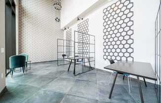 A dining room with a table and chairs.