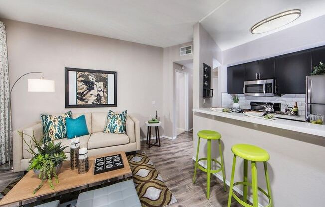 a living room with a couch and two stools