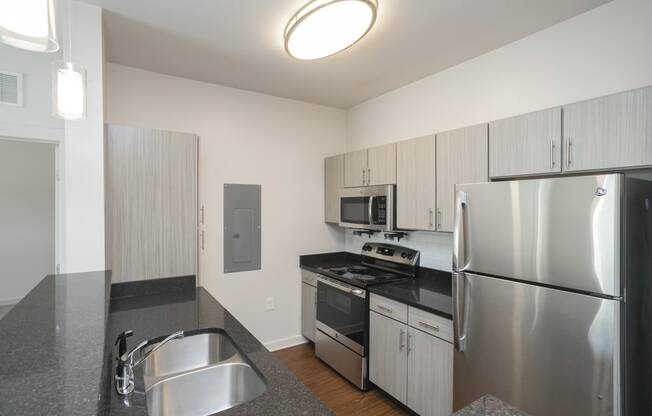 a kitchen with gray countertops and stainless steel appliances