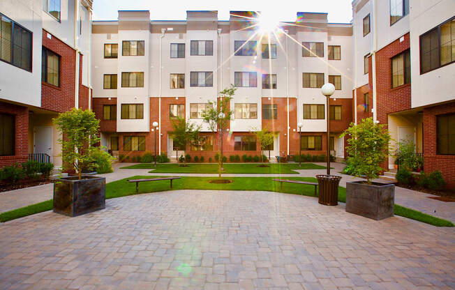 The Lofts at Middlesex in Middlesex NJ courtyard view with an elegant grassy area and various plants to welcome you