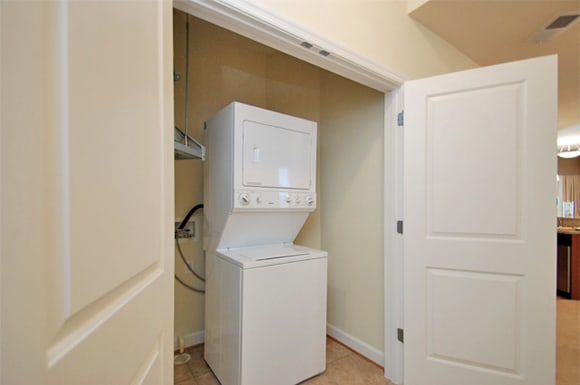 Stacked washer and dryer with door