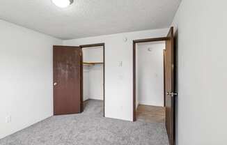 A room with a brown door and a white door.