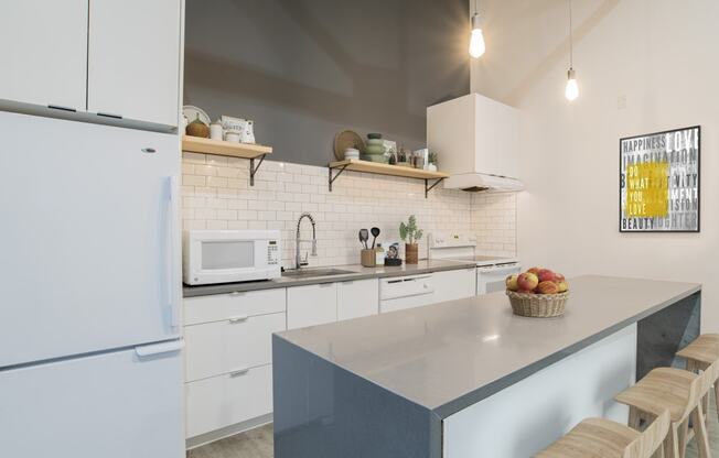 a kitchen with white cabinets and a counter top