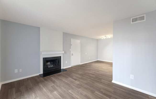 Living room with a fireplace and wooden floors  at Governors House, Huntsville, Alabama