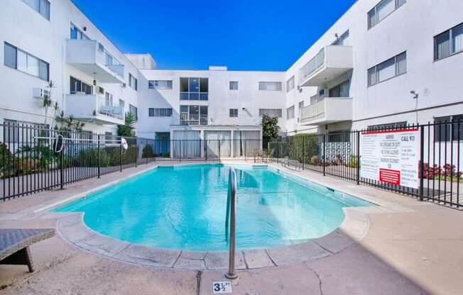 a swimming pool in front of an apartment building