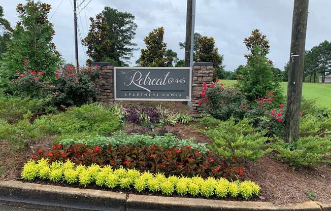 a sign for the relentless landscaping company in front of a garden