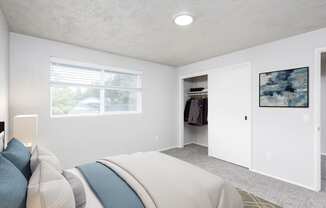 a bedroom with a bed and a closet and a window