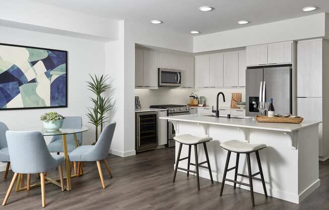 an open kitchen and dining area with a bar and stools