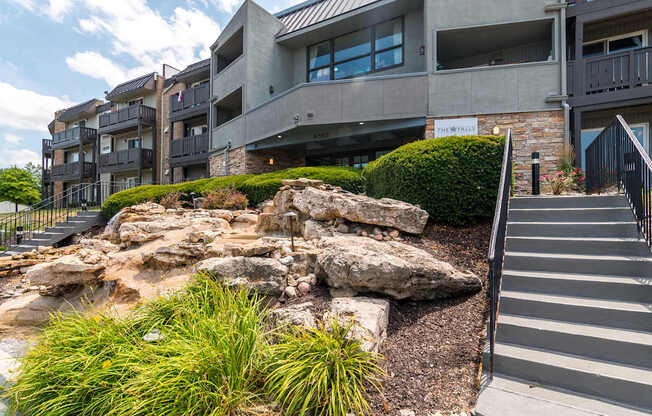 A modern building with a rocky outcrop in front.