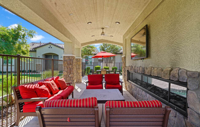 a covered patio with furniture and a table and chairs