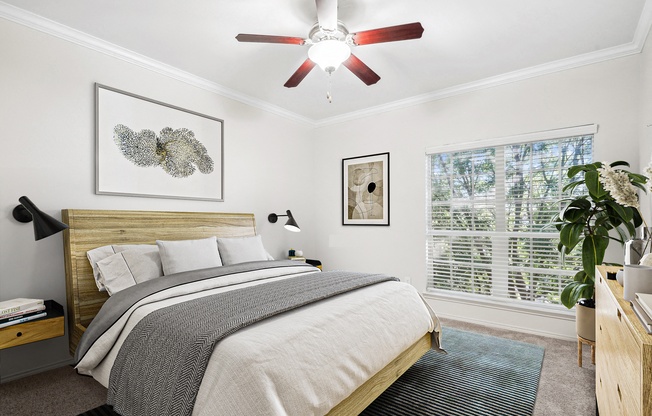 a bedroom with a bed and a ceiling fan at La Ventura Apartments, Texas, 75093