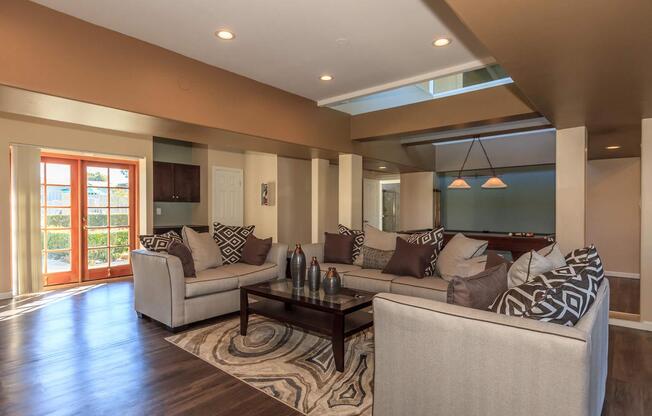 a living room filled with furniture and a large window