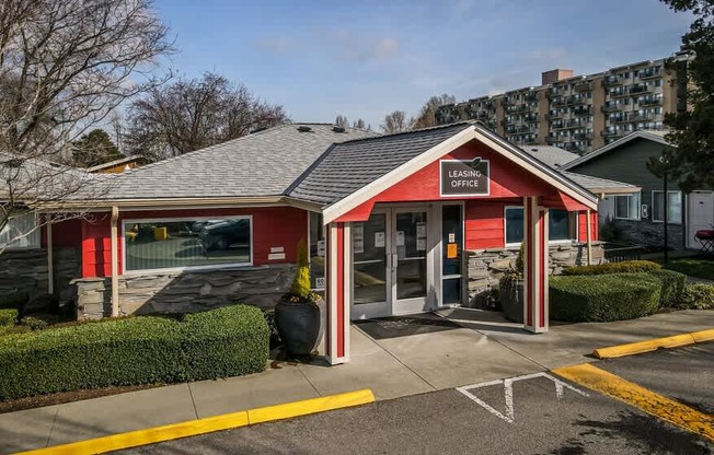 A red and white building with the words "Leasing" on the front.
