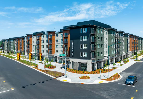 an aerial view of a large apartment complex with a car parked on the side of the road at STATION BY VINTAGE, COVINGTON