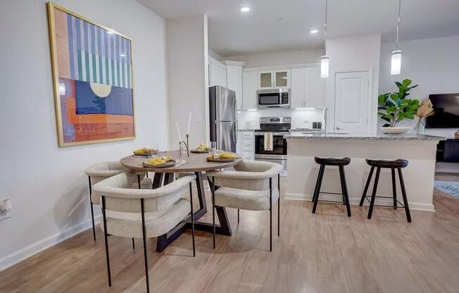 A kitchen with a dining table and chairs.at Evolve at Parkway Apartment Homes, Concord, 28027