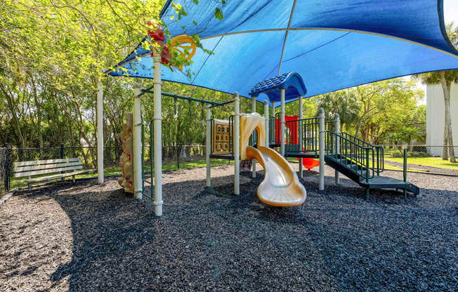 Pet-Friendly Apartments in Coconut Creek, FL – Waterview at Coconut Creek – playground with a slide and other playground equipment