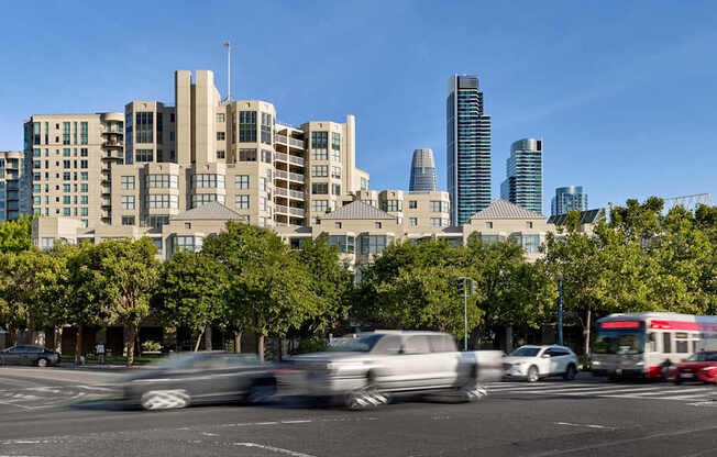 Cars are driving on a road in a city.