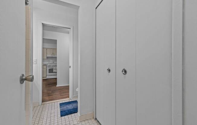 a bedroom with white closets and a door to a kitchen at Edge At Farmington Hills - Farmington Hills, MI, Farmington Hills, Michigan