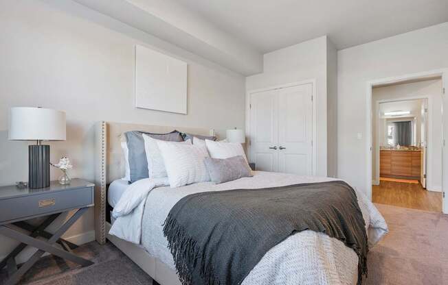 a bedroom with a large bed and a door to a bathroom