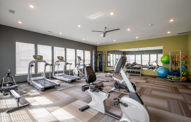 Fitness center with treadmills and other exercise equipment at Mosaic Apartments in Avon, Indiana