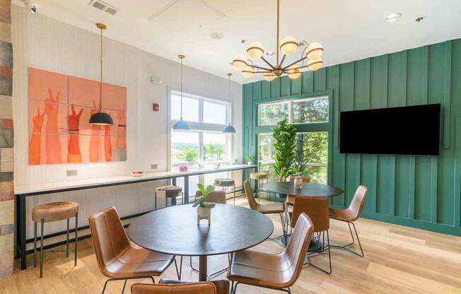 A modern dining room with a round table and chairs.