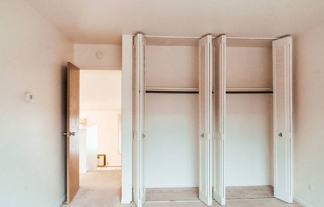 A room with a white door and a white wall.