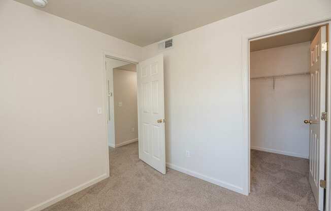 A room with a white door and a carpeted floor at Autumn Oaks Apartments, Roseville, CA, 95678
