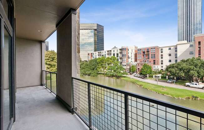 A balcony overlooks a river and a cityscape.