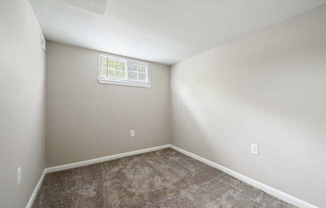 an empty room with carpet and a window at ReNew Odenton