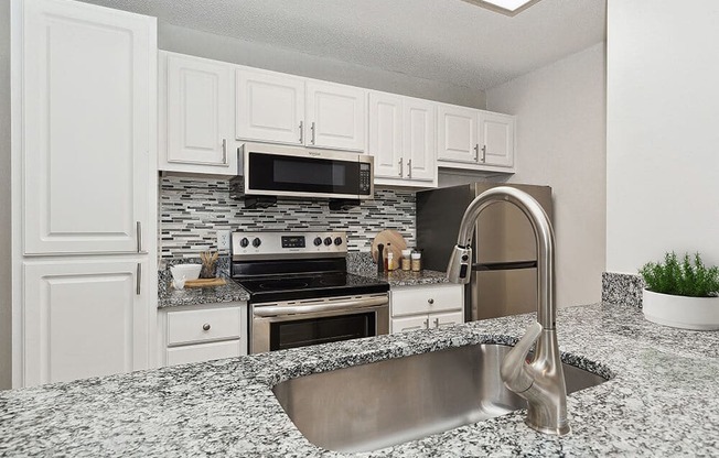 Model Kitchen with White Cabinets at Seven Lakes at Carrollwood Apartments in Tampa, FL.