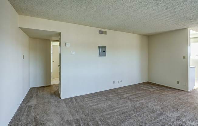 an empty living room with white walls and carpet at Terrace View Apartments, Daly City, CA 94015