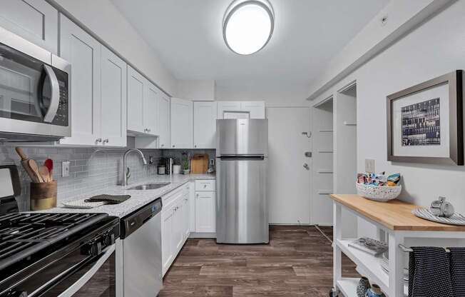 Kitchen with white cabinets and a stainless steel refrigerator at Columbia Pointe, Maryland , 21045