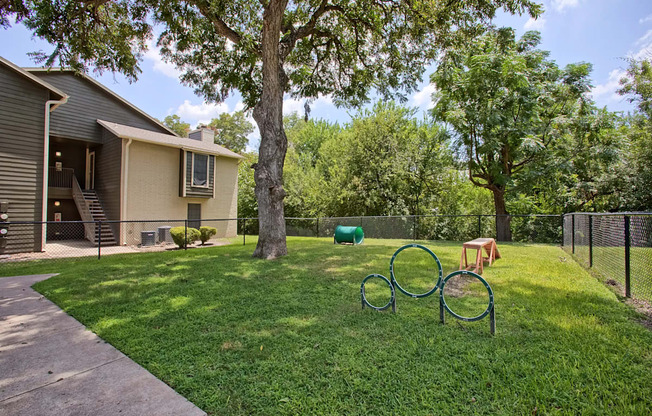 A house with a green lawn and a tree.