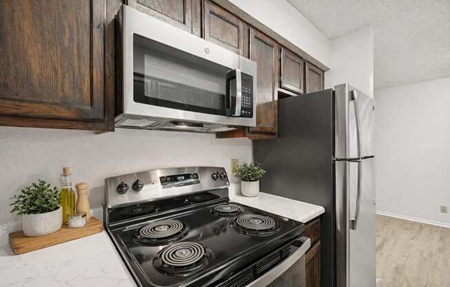A kitchen with a black stove top oven and a black refrigerator.