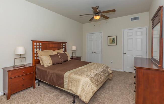 a bedroom with a bed and desk in a small room