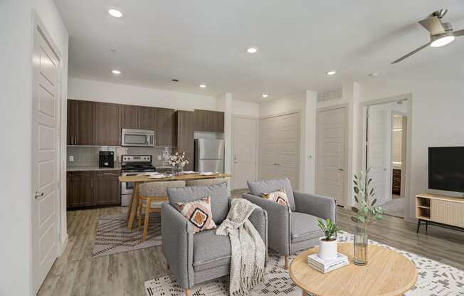 a living room and kitchen with couches and a table