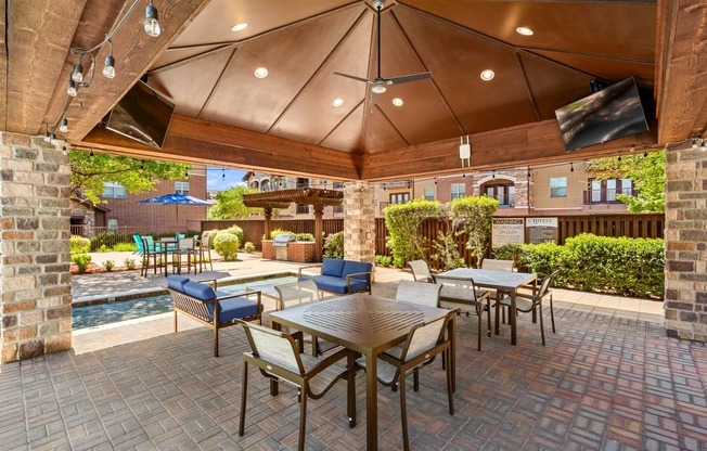 a patio with tables and chairs and a pool