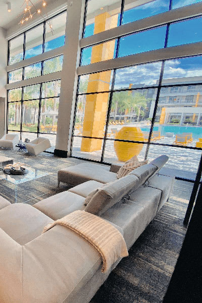 a living room filled with furniture and a large window  at Fusion, Florida